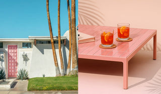 Pink outdoor table with drinks next to a palm tree and house